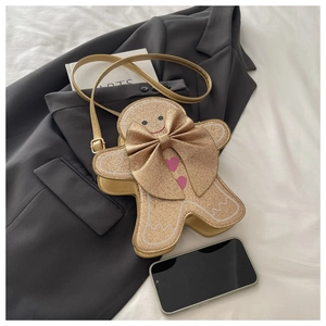 Détail du sac bandoulière bonhomme pain d'épice à paillettes avec nœud doré décoratif