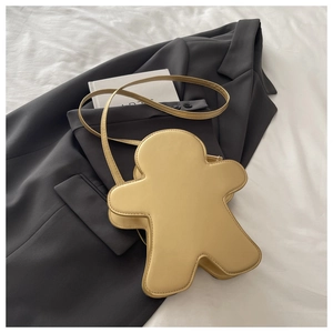 Détail du sac bandoulière bonhomme de pain d'épices avec coutures sur similicuir doré