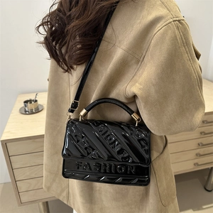 Elegant black patent leather crossbody bag with FASHION embossed texture and top handle
