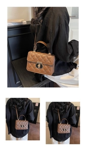 Close-up of brown quilted leather texture and gold-tone CD logo metal buckle on handbag