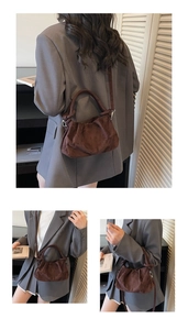 Detail of dark brown ruched cloud bag in suede texture with detachable shoulder strap