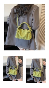 Detail of green pleated suede bag with unique knotted handle and adjustable shoulder strap