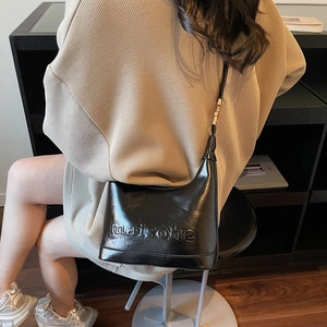 Glossy black crescent shoulder bag with embossed letters and adjustable gold buckle