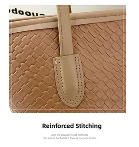Detailed close-up of reinforced stitching on khaki woven leather tote bag handle