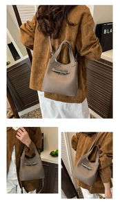 Detail of grey lychee leather bucket bag with metal buckle and detachable shoulder strap