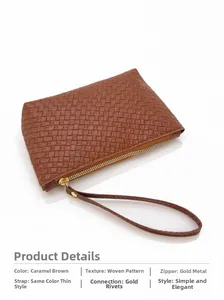 Detail of woven texture on caramel brown leather clutch with gold zipper and wrist strap