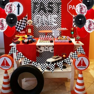 Racing theme birthday party kit with FAST ONE foil balloons and checkered pennant banners