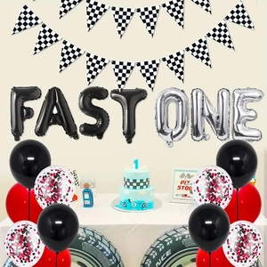 Racing theme first birthday party set with FAST ONE foil balloons and checkered flags