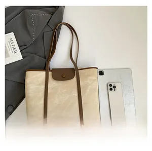 Top view of a large canvas tote bag showing interior space with a tablet and phone