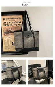 Detailed close-up of retro gray canvas tote bag with black faux leather trim and button closure