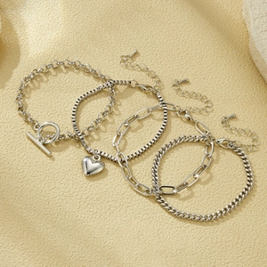 Set of 4 silver chain bracelets featuring a heart pendant and OT toggle clasp