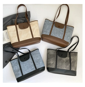 Detail of multi-color tote bags featuring premium canvas and leather patchwork textures