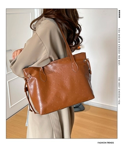 Shoulder tote bag in caramel brown leather with embossed cartoon and SKE GIRL text pattern