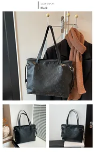 Detail view of black faux leather tote with embossed cat pattern and long shoulder strap