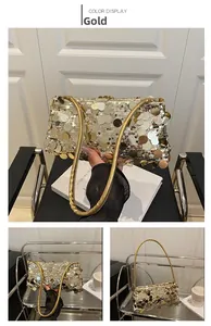Detailansicht der glänzenden goldenen Pailletten und des schlanken Griffs der Abendtasche