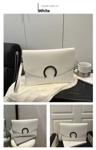 Detailed views of white envelope clutch bag with black C-shaped buckle and wrist strap