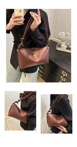 Detail of dark brown leather tote featuring unique knotted straps and vertical stitching