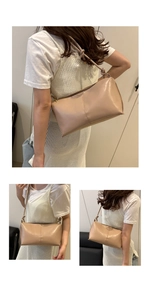 Detail view of beige crossbody bag with knotted shoulder strap and vertical stitching