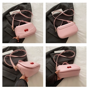 Detail shots of pink crossbody bag with cherry decor from front back and side angles