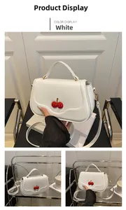 Close-up of white cherry accent purse showing dual cherries and premium texture