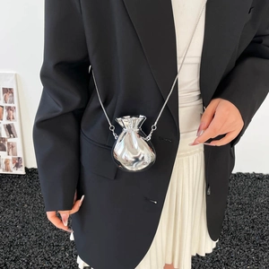 Silver mirror mini pouch bag with chain strap shown on model's shoulder for party style