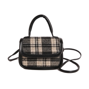 Chic black and grey plaid crossbody bag with black leather straps and top handle