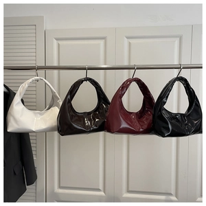Detailed display of crescent-shaped hobo bags in four colors with glossy patent leather finish