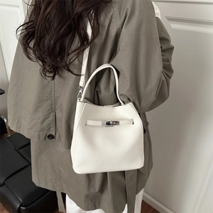 White litchi pattern leather bucket bag with silver rotating lock and shoulder strap