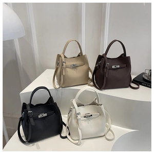 Detailed view of four textured pebbled leather bucket bags in beige, brown, black and white