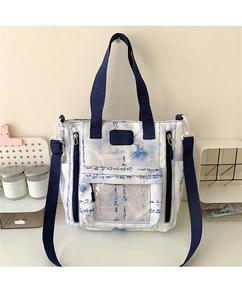 Detail view of canvas tote bag with blue calligraphy print and transparent front pocket