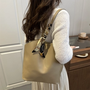 Minimalist khaki large tote bag with decorative vintage scarf on handle for daily commute