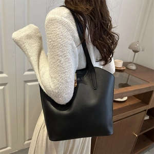 Minimalist black tote bag in matte leather finish for daily office commuting