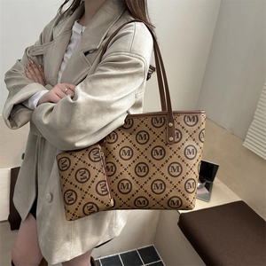 Brown monogram tote bag set with matching pouch shown on a model for daily commute