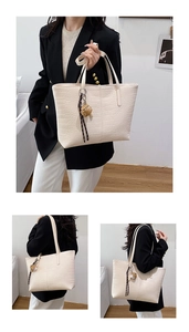 Detailed views of creamy white tote bag with crocodile texture and cute bear pendant charm