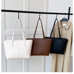 Detailed trio of crocodile pattern tote bags in white, brown, and black colors