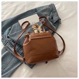 Top view of brown PU leather mini backpack with drawstring closure and ruched handle