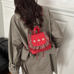 Cute red polka dot mini backpack with floral accents for women in high fashion style