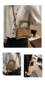 Detail of vintage brown textured leather handbag with knotted handle and curved base