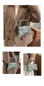 Detailed view of the vintage hourglass textured handbag with double knot handle design