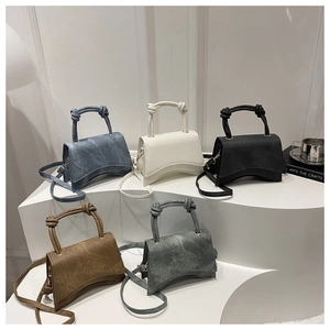 Close-up of hourglass crossbody bags with knotted handles in five different colors