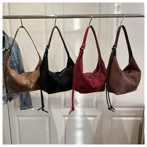 Detail view of four large suede hobo bags in brown black burgundy and dark coffee colors