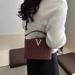 Deep wine red leopard print crossbody bag with golden V hardware and adjustable strap