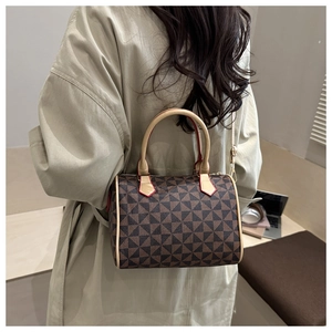 Street style view of a vintage geometric pattern Boston bag with red edge paint details
