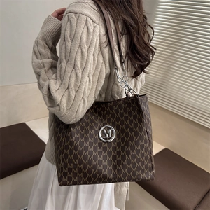 Vintage brown tote bag with M letter print and silver metal logo on shoulder chain strap