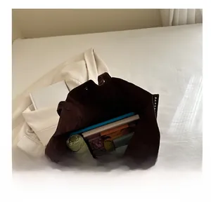 Interior view of spacious dark brown corduroy tote bag showing storage for tablet and daily items
