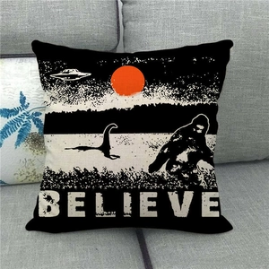 Detail of square linen pillow cover featuring BELIEVE text and mystic sun illustration