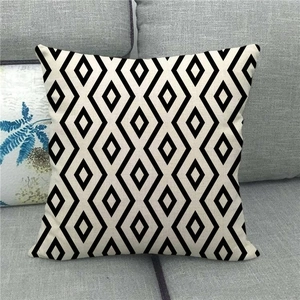 Close-up of geometric black and white linen pillowcase texture on a sofa