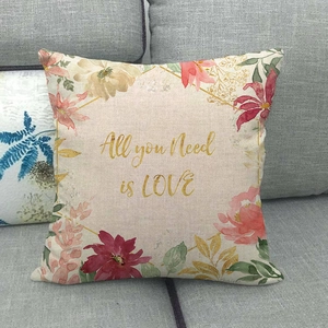 Detail of linen blend cushion cover with flower wreath and All you Need is LOVE text