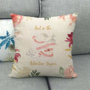 Detail of linen pillowcase with watercolor floral wreath and Just Married wedding text