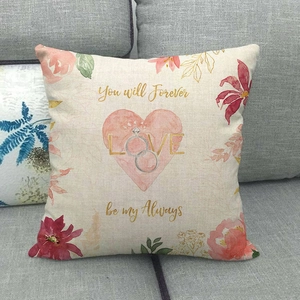 Detailed texture of linen pillowcase with floral heart and romantic text on sofa